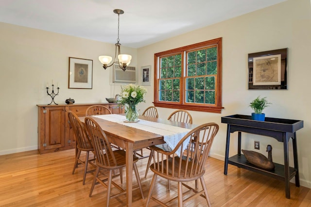 38 Sunset Dr, Brewster, NY 10509 - dining area featuring light wood finished floors, a chandelier, and a wall mounted air conditioner