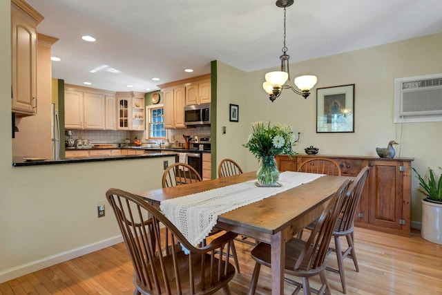 38 Sunset Dr, Brewster, NY 10509 - dining room with light wood-style flooring, a wall mounted AC, recessed lighting, and a chandelier