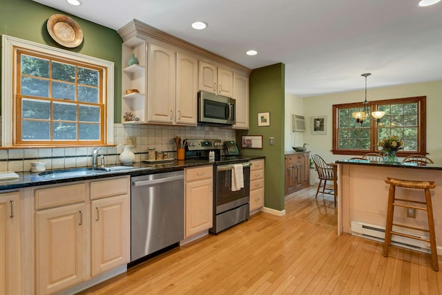 38 Sunset Dr, Brewster, NY 10509 - kitchen with appliances with stainless steel finishes, light wood finished floors, backsplash, hanging light fixtures, and recessed lighting