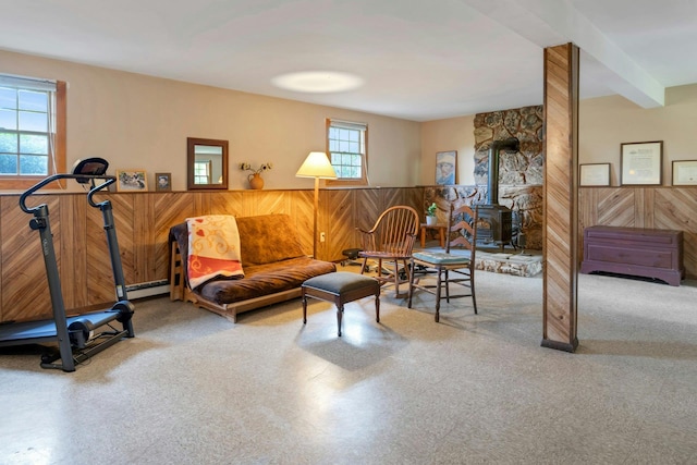 38 Sunset Dr, Brewster, NY 10509 - living room with wooden walls, a wood stove, carpet flooring, and wainscoting