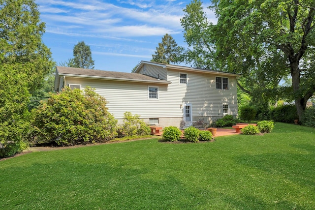 38 Sunset Dr, Brewster, NY 10509 - rear view of house with a lawn and a patio area