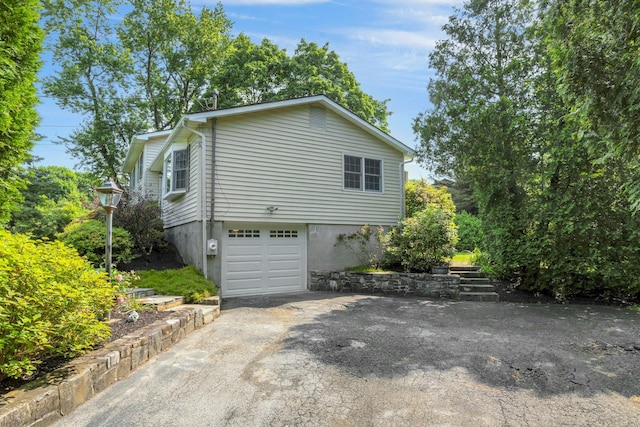 38 Sunset Dr, Brewster, NY 10509 - view of home's exterior featuring an attached garage and driveway