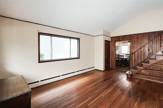 6 Pequot Ave, Port Washington, NY 11050 - empty room featuring baseboard heating, stairs, wood finished floors, and vaulted ceiling