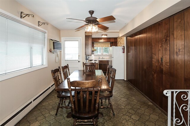 6 Pequot Ave, Port Washington, NY 11050 - dining space with a baseboard heating unit, ceiling fan, a wall mounted AC, and dark floors