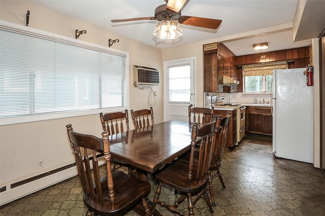 6 Pequot Ave, Port Washington, NY 11050 - dining space featuring a wall mounted air conditioner, ceiling fan, and dark stone finish floors