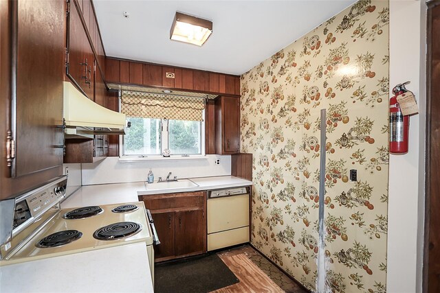 6 Pequot Ave, Port Washington, NY 11050 - kitchen featuring white appliances, under cabinet range hood, a sink, light countertops, and wallpapered walls