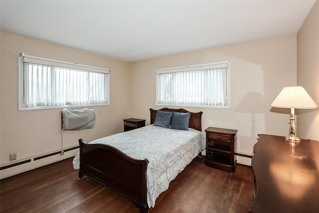 6 Pequot Ave, Port Washington, NY 11050 - bedroom featuring wood finished floors and baseboard heating