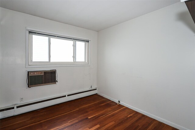 6 Pequot Ave, Port Washington, NY 11050 - spare room with baseboard heating, baseboards, dark wood finished floors, and a wall mounted air conditioner