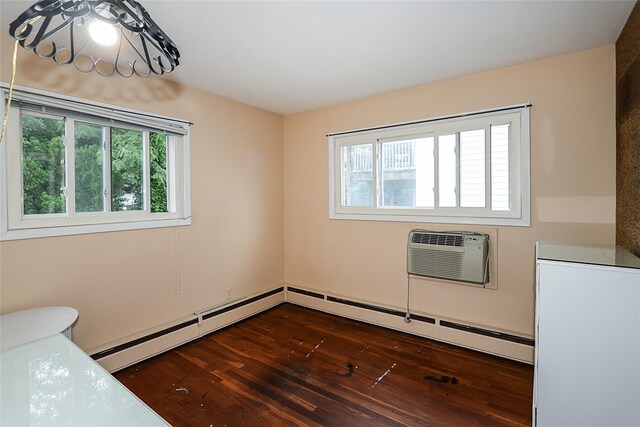 6 Pequot Ave, Port Washington, NY 11050 - spare room with dark wood-style flooring, a wall mounted AC, and baseboard heating