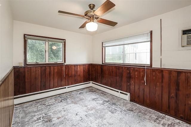 6 Pequot Ave, Port Washington, NY 11050 - empty room featuring a wainscoted wall, wood walls, and a ceiling fan