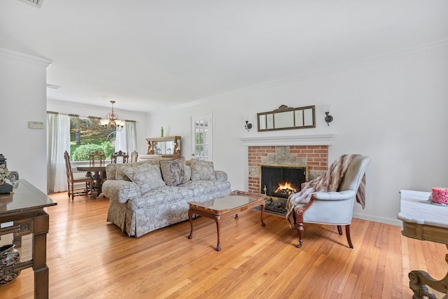 5 Ridgeview Dr, Pleasantville, NY 10570 - living room featuring light wood-style flooring, ornamental molding, a chandelier, and a brick fireplace