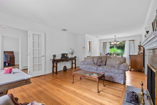5 Ridgeview Dr, Pleasantville, NY 10570 - living area featuring light wood finished floors, a chandelier, crown molding, and a fireplace with flush hearth