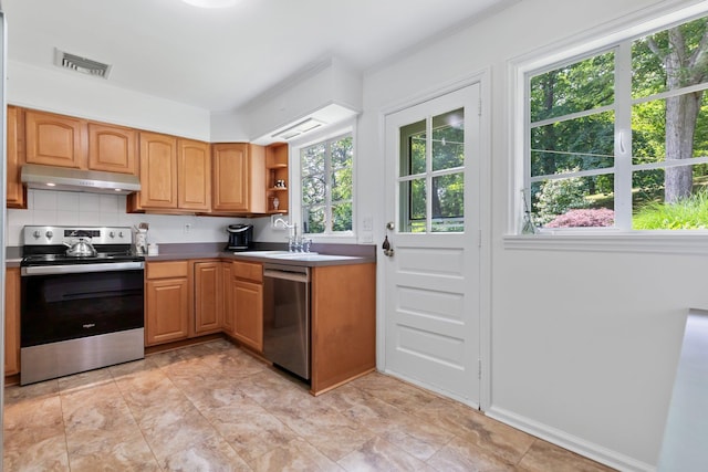 5 Ridgeview Dr, Pleasantville, NY 10570 - kitchen with stainless steel appliances, under cabinet range hood, open shelves, and tasteful backsplash