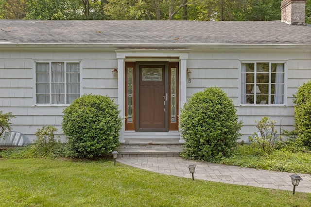5 Ridgeview Dr, Pleasantville, NY 10570 - doorway to property featuring a chimney, a shingled roof, and a lawn