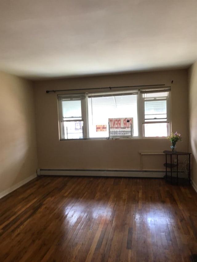 724A E 223rd St, Bronx, NY 10466 - spare room featuring dark wood-style floors, a baseboard heating unit, and baseboards