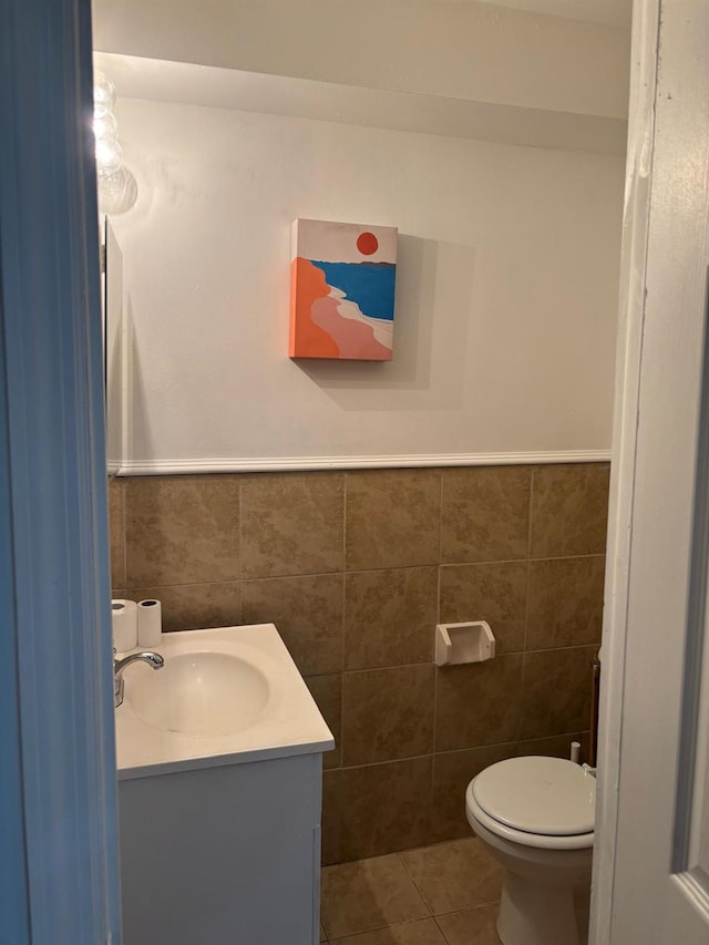 724A E 223rd St, Bronx, NY 10466 - bathroom with tile walls, vanity, tile patterned flooring, toilet, and wainscoting