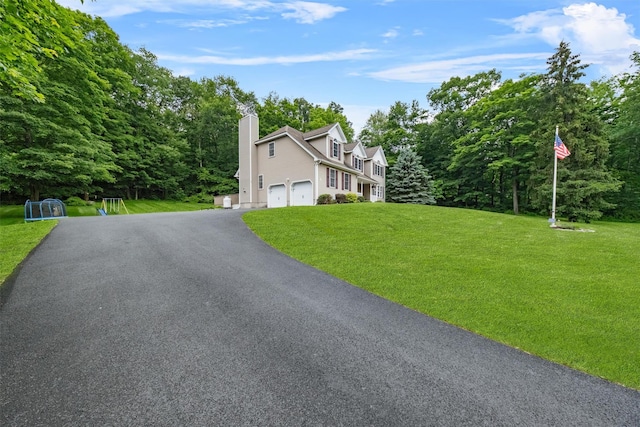 2 SE Ct, Wallkill, NY 12589 - view of front facade featuring a garage, a chimney, driveway, and a front yard