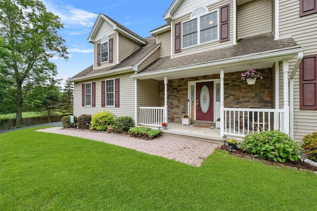 2 SE Ct, Wallkill, NY 12589 - view of front facade with a porch, roof with shingles, a front lawn, and stone siding