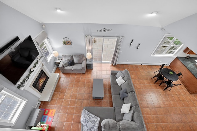 2 SE Ct, Wallkill, NY 12589 - tiled living area featuring lofted ceiling and a glass covered fireplace
