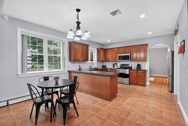 2 SE Ct, Wallkill, NY 12589 - kitchen featuring appliances with stainless steel finishes, arched walkways, a peninsula, a chandelier, and recessed lighting