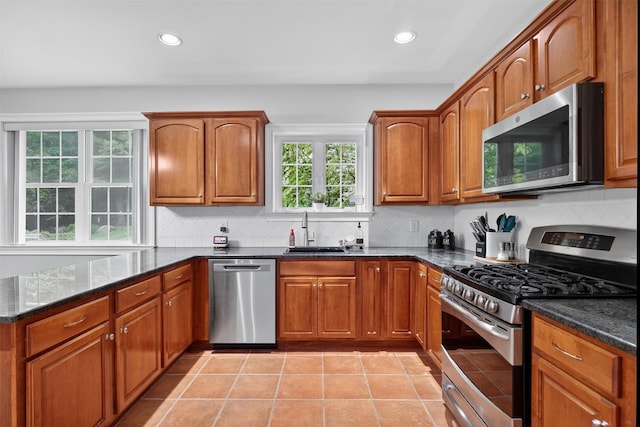 2 SE Ct, Wallkill, NY 12589 - kitchen with stainless steel appliances, dark stone counters, brown cabinets, backsplash, and recessed lighting
