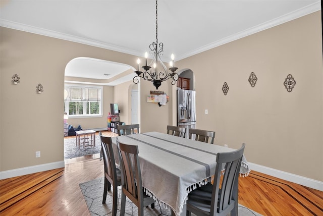 2 SE Ct, Wallkill, NY 12589 - dining area with arched walkways, crown molding, light wood-style floors, and a chandelier