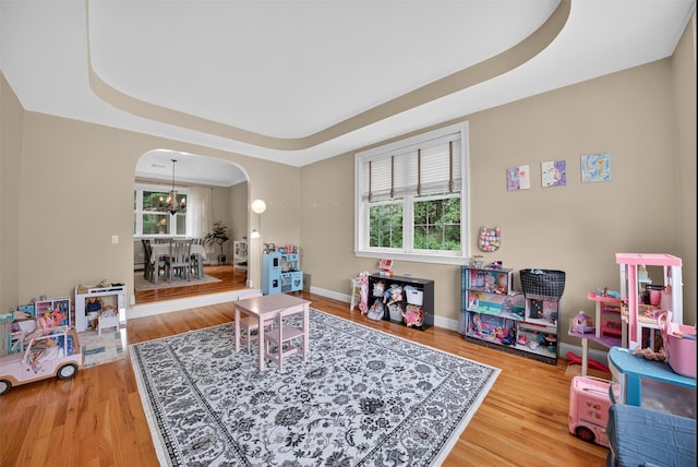 2 SE Ct, Wallkill, NY 12589 - recreation room featuring arched walkways, wood finished floors, a tray ceiling, and a chandelier