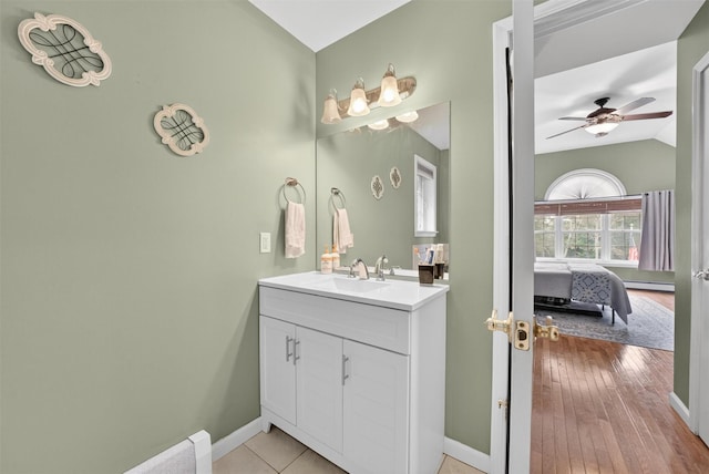 2 SE Ct, Wallkill, NY 12589 - bathroom with vanity, vaulted ceiling, a ceiling fan, a baseboard radiator, and ensuite bathroom