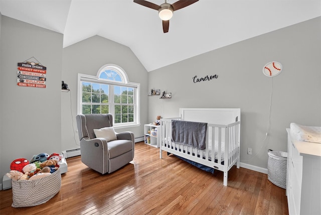 2 SE Ct, Wallkill, NY 12589 - bedroom with a crib, hardwood / wood-style flooring, a baseboard heating unit, vaulted ceiling, and a ceiling fan