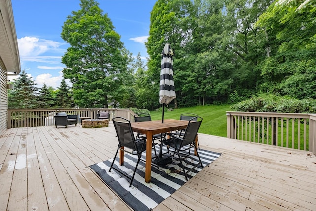 2 SE Ct, Wallkill, NY 12589 - deck featuring a lawn, a fire pit, outdoor dining area, and view of wooded area