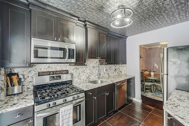 460 Old Town Rd Unit 10A, Port Jefferson Station, NY 11776 - kitchen featuring appliances with stainless steel finishes, an ornate ceiling, backsplash, light stone countertops, and dark wood-type flooring