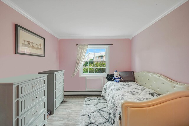 460 Old Town Rd Unit 10A, Port Jefferson Station, NY 11776 - bedroom with a baseboard heating unit, light wood-style flooring, and crown molding