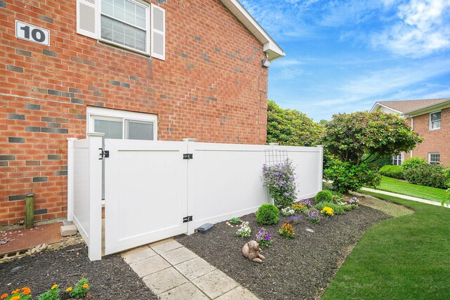 460 Old Town Rd Unit 10A, Port Jefferson Station, NY 11776 - view of property exterior featuring a gate and brick siding