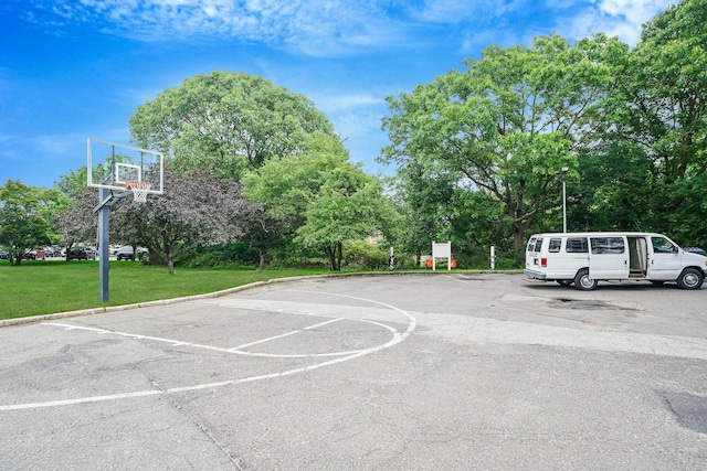 460 Old Town Rd Unit 10A, Port Jefferson Station, NY 11776 - view of sport court with a lawn, community basketball court, and view of wooded area