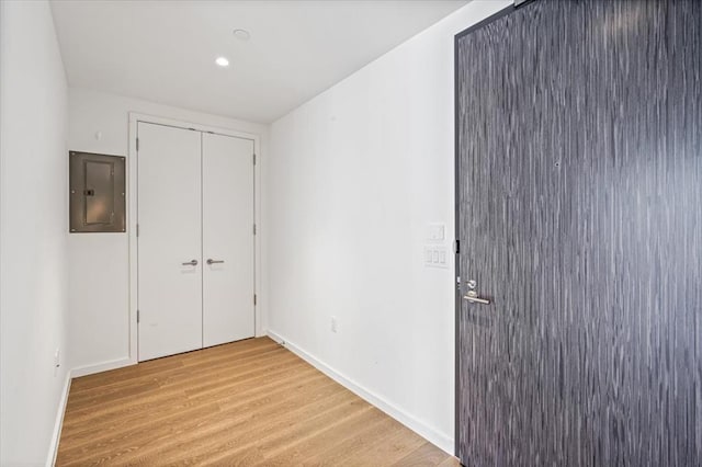 133-36 37th Ave Unit 11H, Flushing, NY 11354 - unfurnished bedroom with electric panel, light wood-style flooring, and a closet