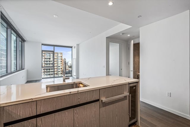133-36 37th Ave Unit 11H, Flushing, NY 11354 - kitchen with dark wood-style flooring, light stone countertops, open floor plan, and recessed lighting