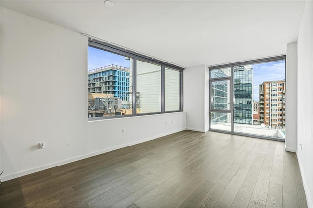 133-36 37th Ave Unit 11H, Flushing, NY 11354 - spare room featuring hardwood / wood-style flooring and a view of city