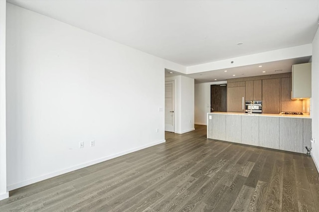 133-36 37th Ave Unit 11H, Flushing, NY 11354 - unfurnished living room with dark wood finished floors and recessed lighting