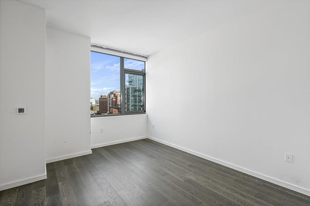 133-36 37th Ave Unit 11H, Flushing, NY 11354 - empty room featuring dark wood finished floors and a view of city