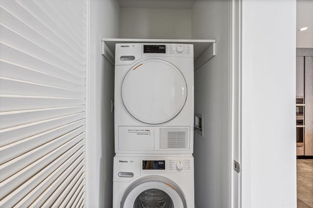 133-36 37th Ave Unit 11H, Flushing, NY 11354 - washroom featuring estacked washer and dryer