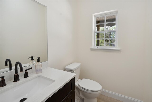 117 Currans, Middle Island, NY 11953 - half bathroom featuring vanity, toilet, and baseboards