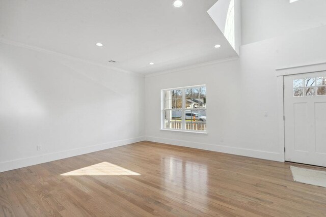 117 Currans, Middle Island, NY 11953 - entrance foyer with healthy amount of natural light, ornamental molding, recessed lighting, baseboards, and light wood-style flooring
