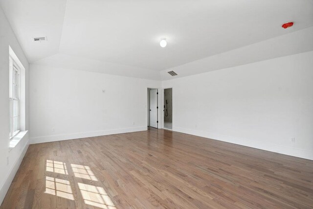 117 Currans, Middle Island, NY 11953 - spare room with wood finished floors, baseboards, and lofted ceiling