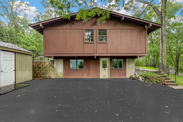 78 College Rd, Monsey, NY 10952 - rustic home featuring stairway, a patio, and an outdoor structure