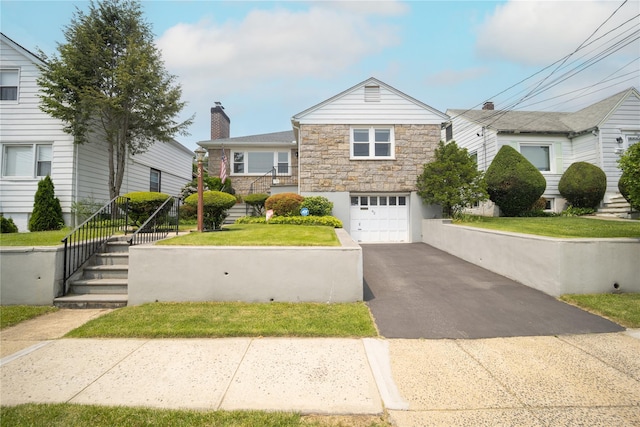 62 Murray Ave, Yonkers, NY 10704 - view of front facade featuring stairway, asphalt driveway, an attached garage, a chimney, and stone siding