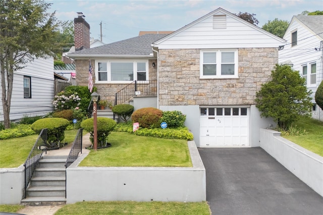 62 Murray Ave, Yonkers, NY 10704 - view of front of property with stone siding, an attached garage, a front lawn, and driveway