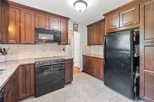 62 Murray Ave, Yonkers, NY 10704 - kitchen with black appliances, decorative backsplash, light stone counters, and light tile patterned flooring