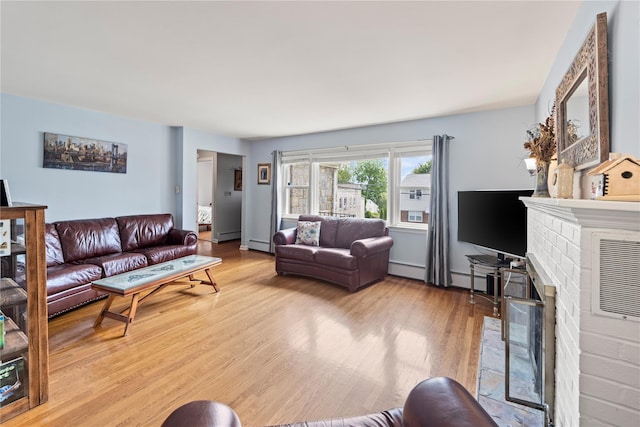 62 Murray Ave, Yonkers, NY 10704 - living room with light wood-style flooring, a fireplace, a baseboard radiator, and baseboard heating