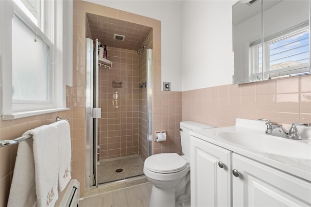 62 Murray Ave, Yonkers, NY 10704 - bathroom with tile walls, a shower stall, vanity, and wood finished floors