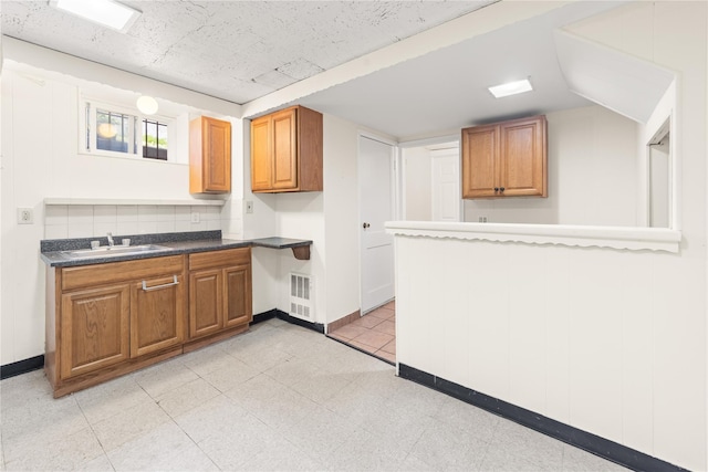 62 Murray Ave, Yonkers, NY 10704 - kitchen featuring dark countertops and brown cabinets